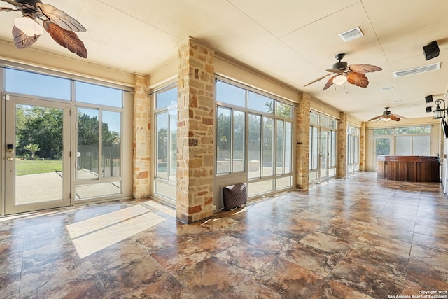 125 Creek Spgs, Boerne, TX 78006 - unfurnished sunroom featuring stone finish flooring, visible vents, a jacuzzi, and a healthy amount of sunlight