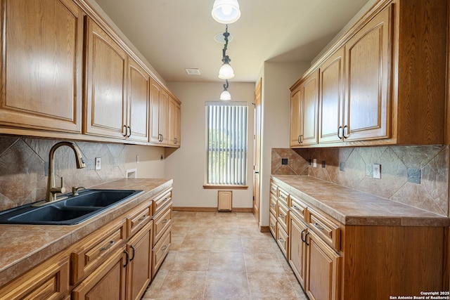 125 Creek Spgs, Boerne, TX 78006 - kitchen with pendant lighting, decorative backsplash, baseboards, and a sink