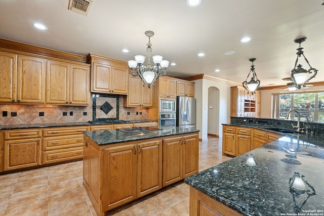 125 Creek Spgs, Boerne, TX 78006 - kitchen with a sink, a large island, visible vents, arched walkways, and appliances with stainless steel finishes