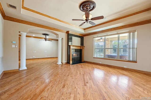125 Creek Spgs, Boerne, TX 78006 - unfurnished living room with ornamental molding, a ceiling fan, a tray ceiling, and decorative columns
