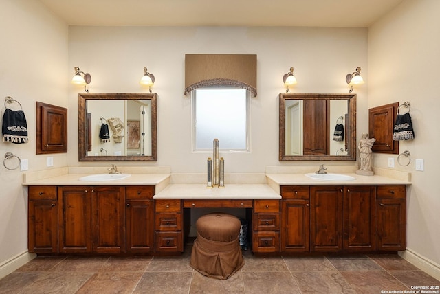 full bathroom with vanity and baseboards