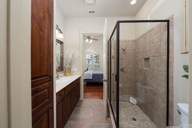 bathroom featuring a shower stall, vanity, ceiling fan, visible vents, and ensuite bathroom