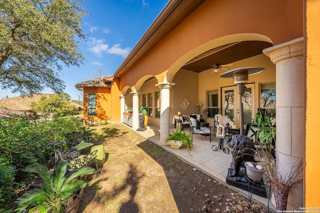 exterior space featuring ceiling fan, stucco siding, and a patio area