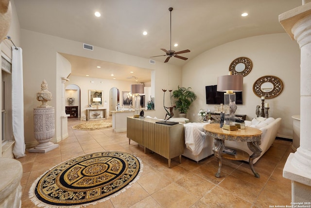 living area with lofted ceiling, visible vents, ceiling fan, arched walkways, and recessed lighting