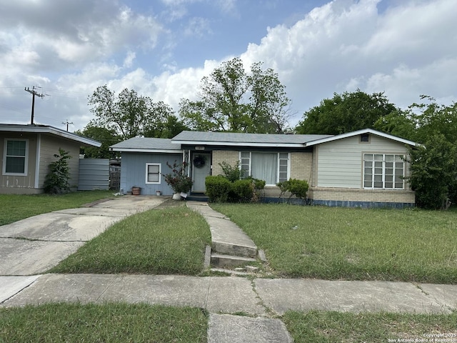 ranch-style house featuring a front yard, concrete driveway, and brick siding