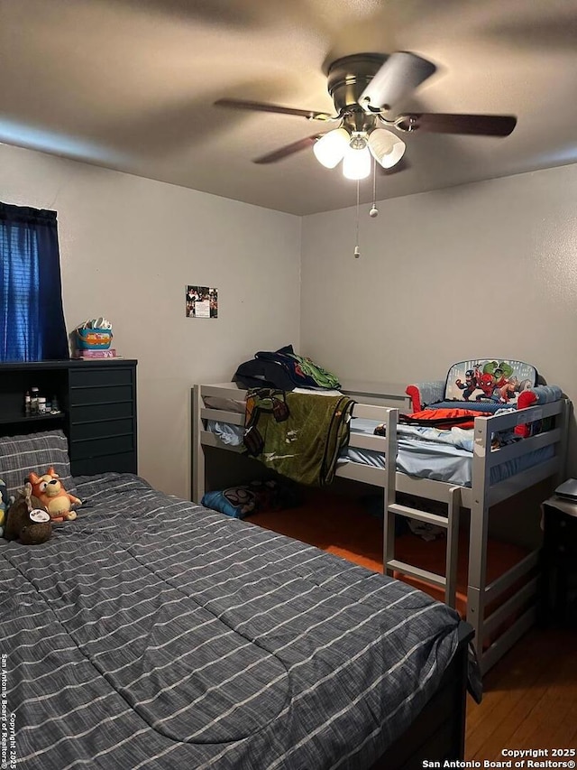 bedroom featuring a ceiling fan and wood finished floors