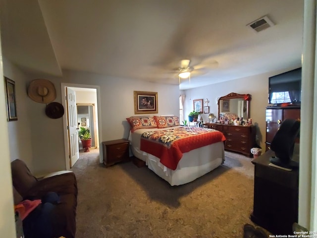 carpeted bedroom featuring visible vents and ceiling fan