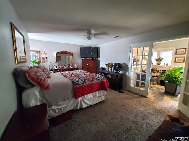 carpeted bedroom with visible vents and ceiling fan