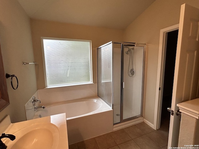 bathroom featuring a garden tub, a stall shower, and tile patterned flooring