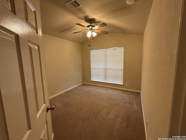 carpeted empty room with baseboards, visible vents, a ceiling fan, and lofted ceiling