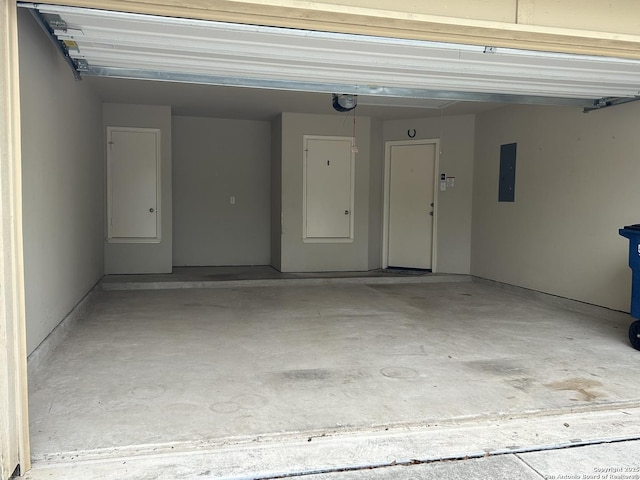 garage with electric panel and a garage door opener