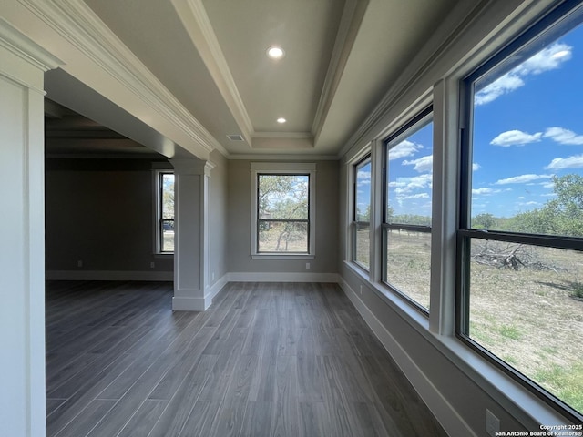 spare room with dark wood finished floors, recessed lighting, baseboards, crown molding, and a tray ceiling