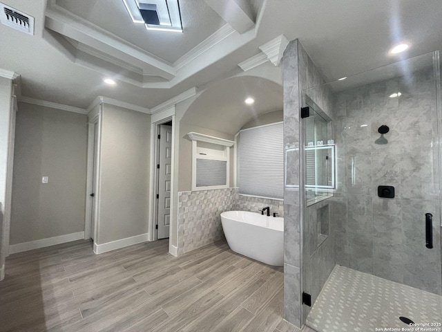 bathroom featuring a shower stall, crown molding, visible vents, a soaking tub, and wood finished floors