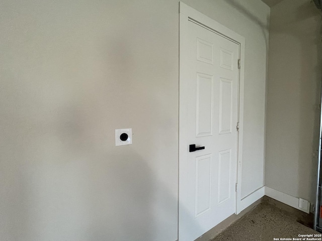 clothes washing area with electric dryer hookup, laundry area, and baseboards