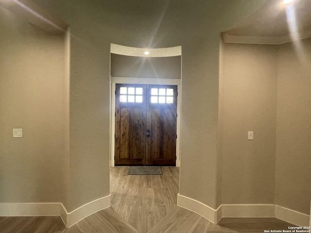 entryway with wood finished floors and baseboards