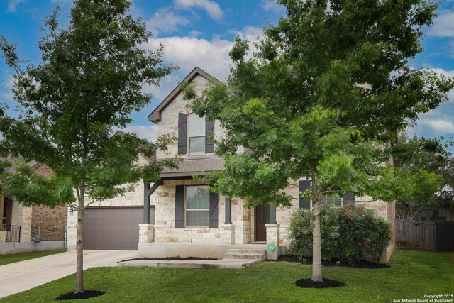 723 Decathlon, San Antonio, TX 78245 - view of property hidden behind natural elements featuring fence, a front lawn, concrete driveway, and stone siding