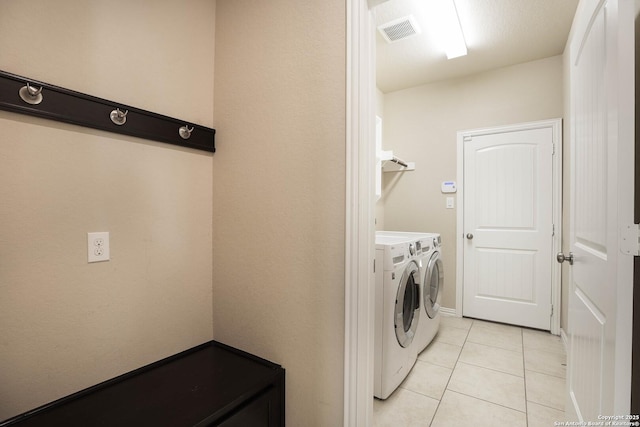 723 Decathlon, San Antonio, TX 78245 - laundry area with visible vents, light tile patterned floors, separate washer and dryer, and laundry area
