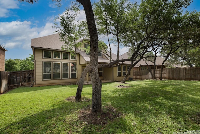 723 Decathlon, San Antonio, TX 78245 - rear view of house featuring a lawn, a fenced backyard, and roof with shingles