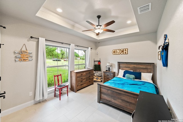 bedroom with crown molding, a raised ceiling, ceiling fan, visible vents, and baseboards