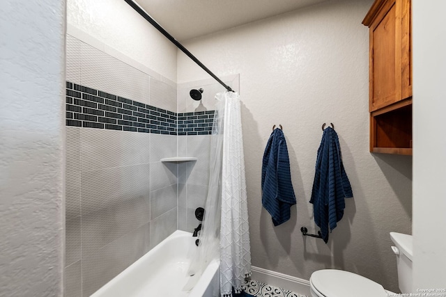 bathroom featuring a textured wall, toilet, and shower / tub combo with curtain