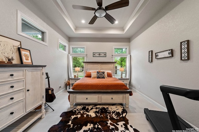 bedroom with ornamental molding, light tile patterned flooring, baseboards, and a tray ceiling