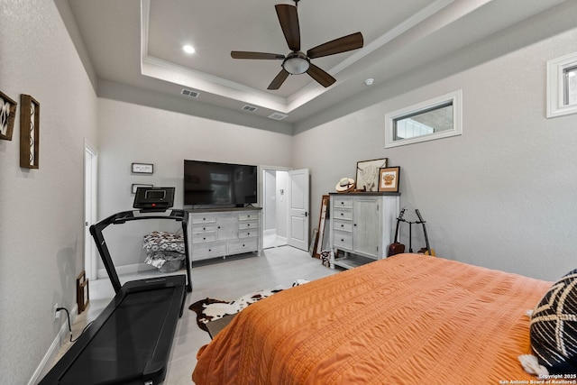 bedroom with ornamental molding, a ceiling fan, visible vents, and a raised ceiling