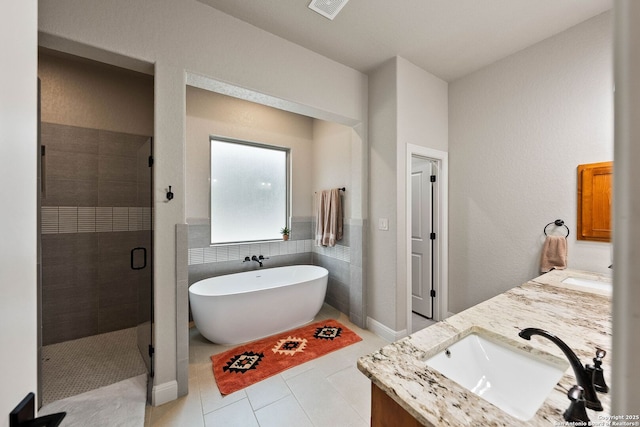 bathroom with a shower stall, a sink, double vanity, visible vents, and a freestanding tub