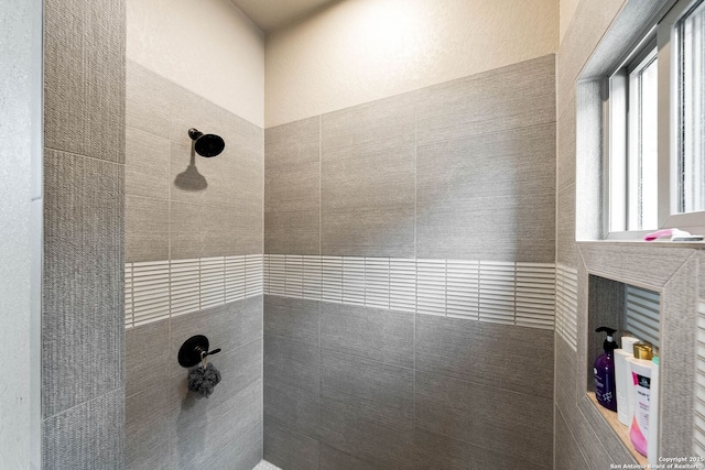 full bathroom with tiled shower