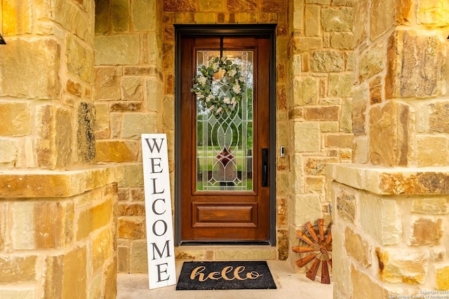 entrance to property with stone siding