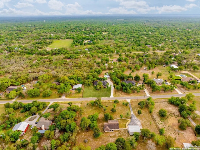birds eye view of property featuring a forest view