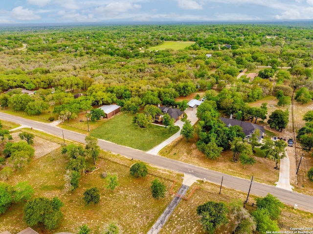 drone / aerial view featuring a wooded view