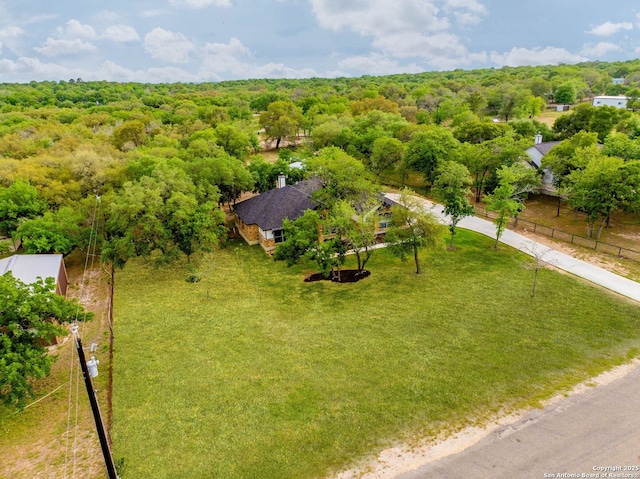 birds eye view of property with a view of trees