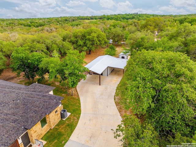 birds eye view of property with a forest view