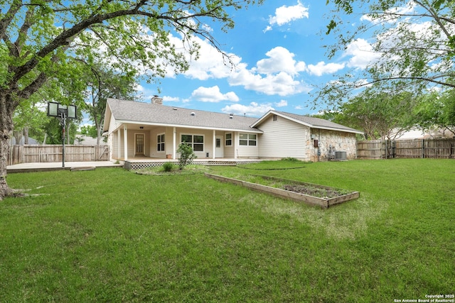 back of house featuring a patio, a chimney, central air condition unit, a lawn, and a fenced backyard