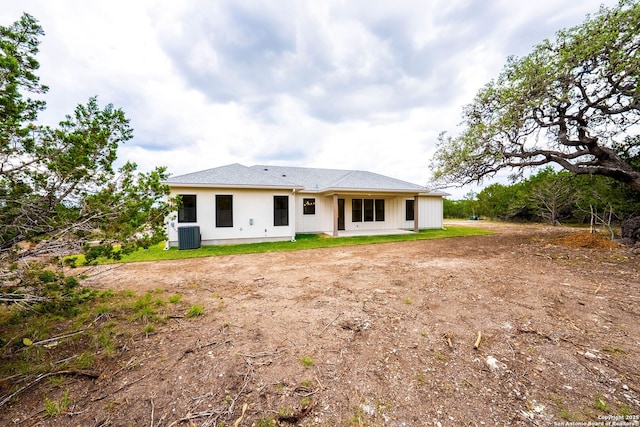 265 Vaquero Dr, Pipe Creek, TX 78063 - rear view of property featuring cooling unit and dirt driveway