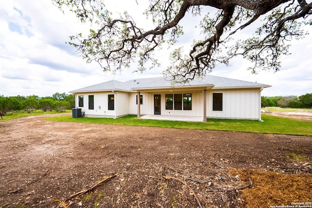 265 Vaquero Dr, Pipe Creek, TX 78063 - back of house featuring central AC, a patio area, and a lawn