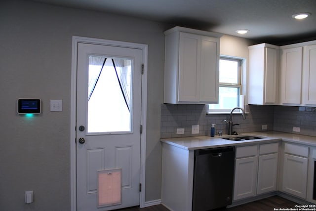 kitchen with a healthy amount of sunlight, light countertops, dishwasher, and a sink