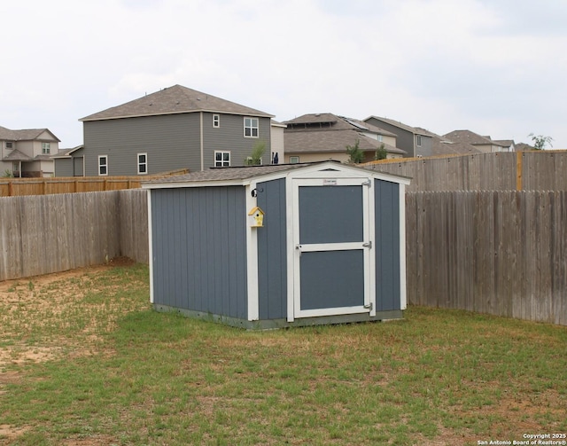 view of shed with a fenced backyard and a residential view