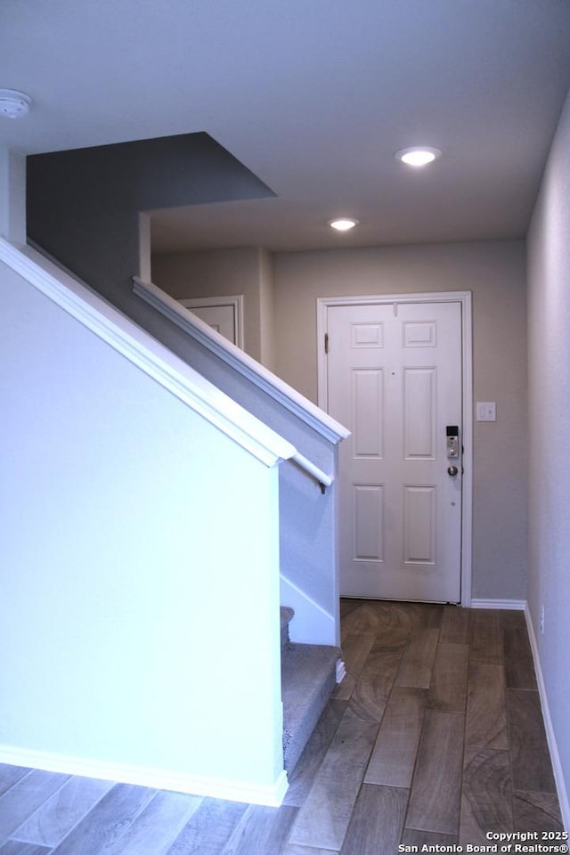entryway with baseboards, recessed lighting, and stairs
