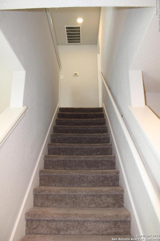 stairway featuring visible vents and recessed lighting