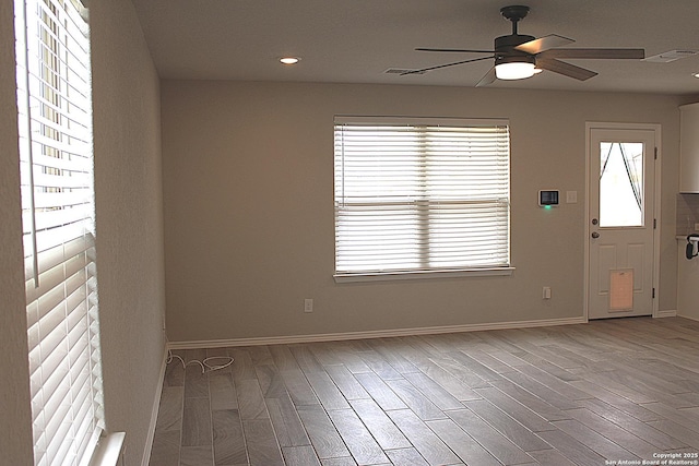 unfurnished room featuring recessed lighting, a ceiling fan, visible vents, baseboards, and wood finished floors