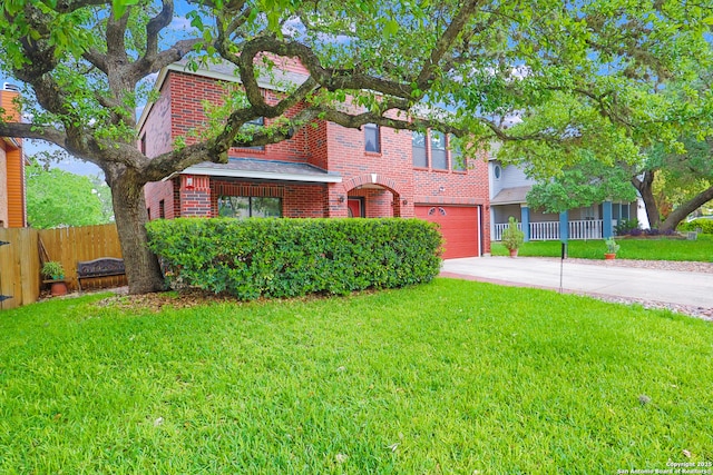 view of front of property featuring brick siding, fence, driveway, a front lawn, and an attached garage