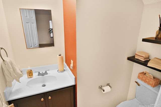 half bath featuring toilet and vanity