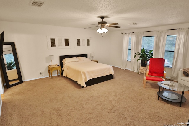 bedroom with baseboards, visible vents, a textured ceiling, and carpet flooring