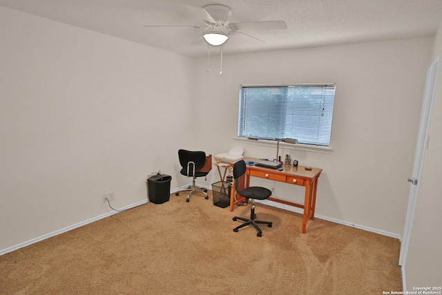 office space with baseboards, ceiling fan, and carpet