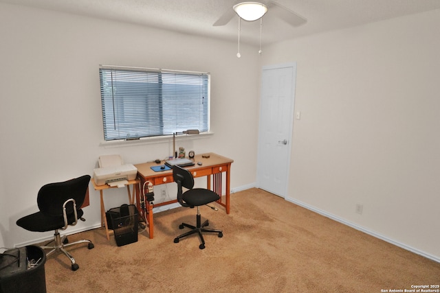 office space featuring baseboards, a ceiling fan, and carpet
