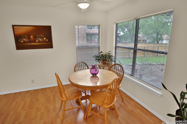 dining room with light wood-style floors, ceiling fan, and baseboards