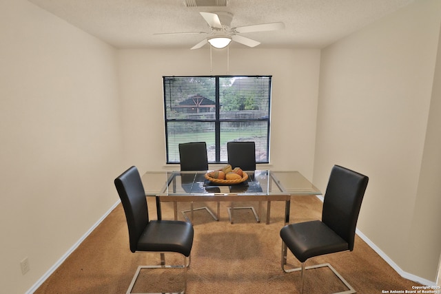office area with a textured ceiling, ceiling fan, baseboards, and carpet floors