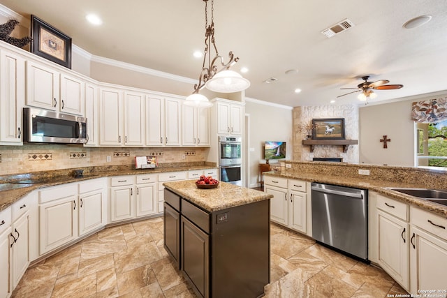 kitchen with visible vents, appliances with stainless steel finishes, crown molding, and decorative backsplash