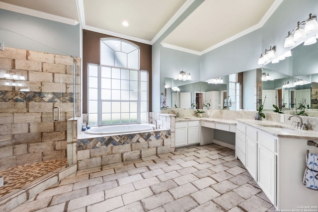 bathroom featuring a garden tub, a shower stall, crown molding, and vanity